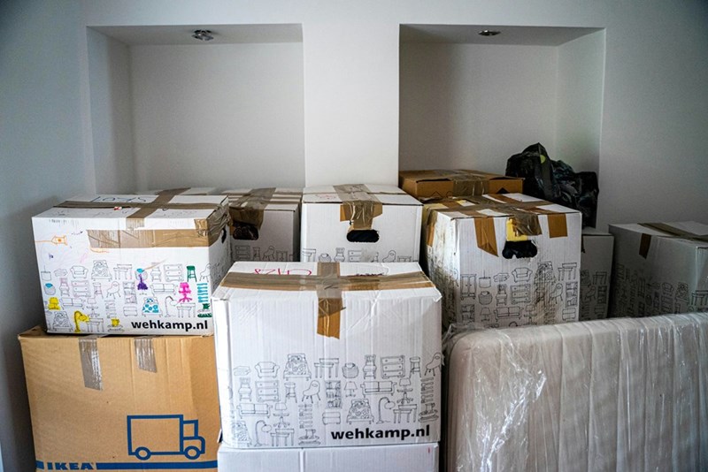 Moving boxes fill a room after an unexpected move-in situation.