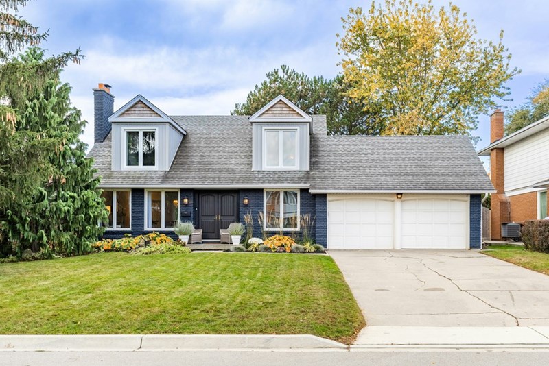 A suburban home with a private driveway and garage in a residential neighborhood.