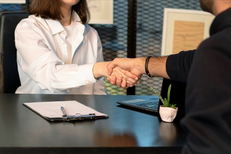 Client and freelancer shaking hands.