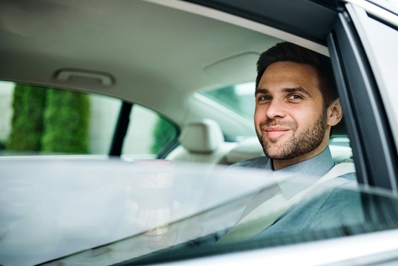 Young businessman at the back of an Uber.