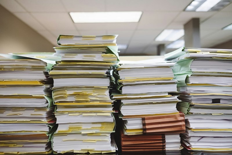 Stacks of paper documents and file folders.