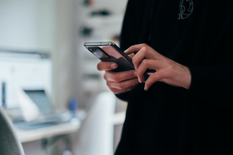 An employee uses their employer's authenticator app on their phone.