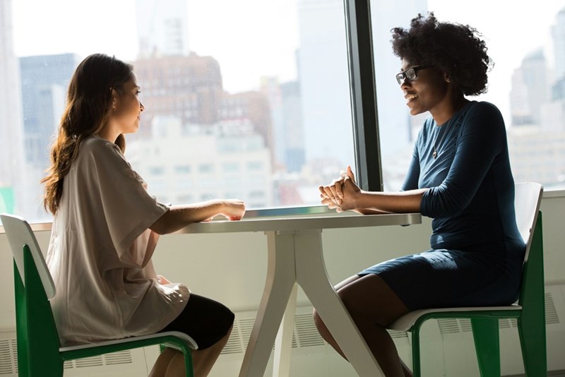 A job candidate speaks with a recruiter during an interview after searching for new career opportunities.