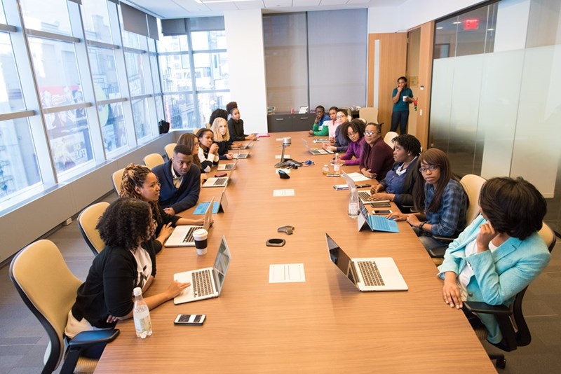 Corporate team gathered around a conference table during a leadership review meeting.