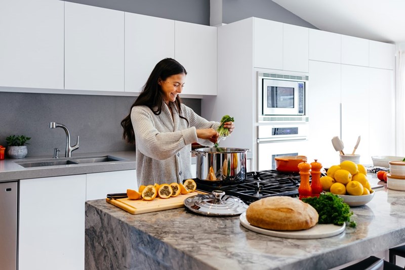 A woman cooking a homemade meal. 