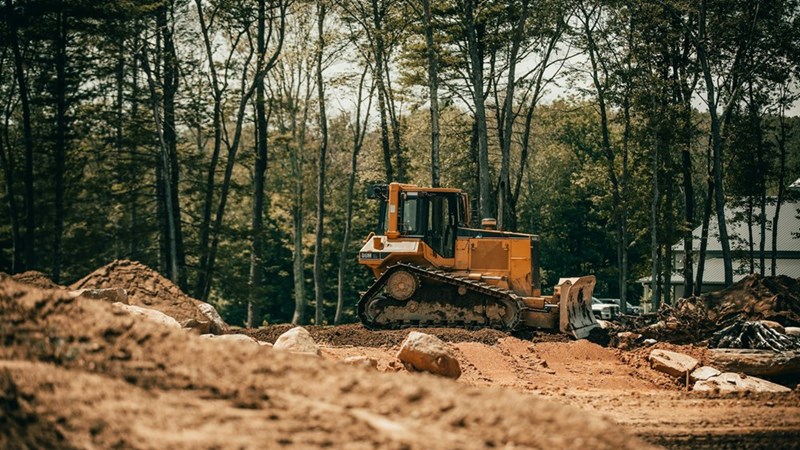 A small excavator on a construction lot.