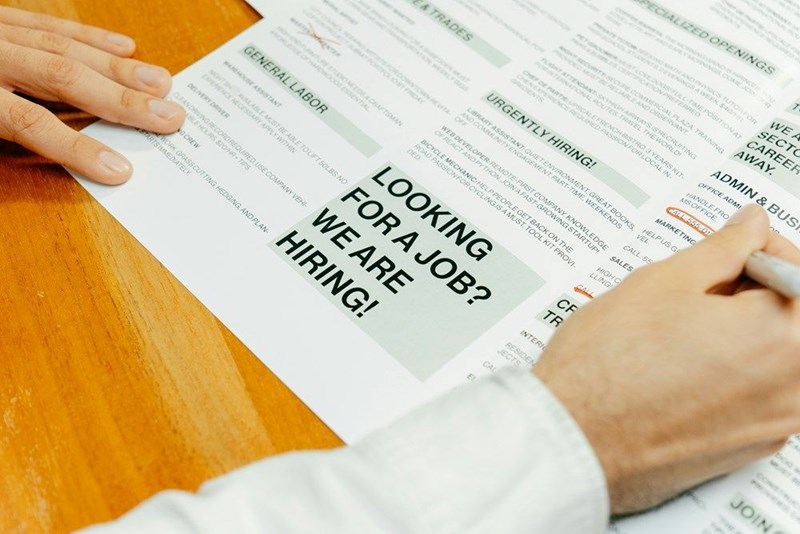 Job ads in a brochure representing the job search process for job seekers.