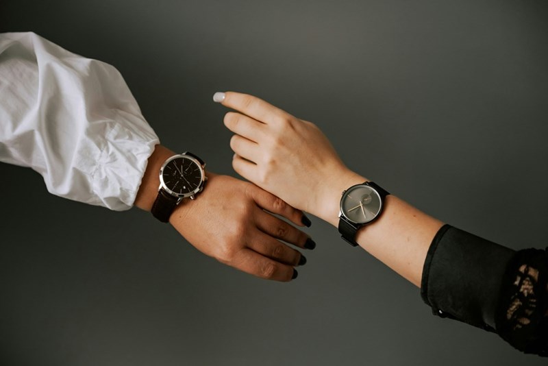 A couple of people that are wearing watches