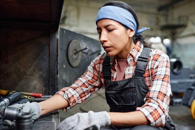 New employee operating machinery in a metalworking facility.