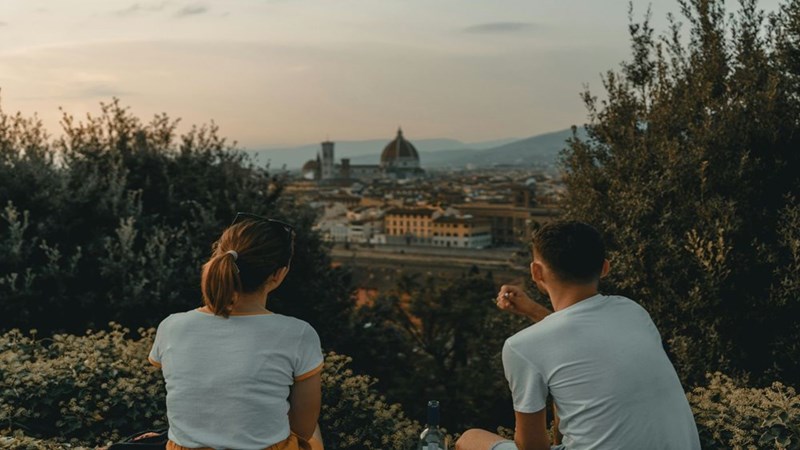 A couple traveling around the world together. Still frame for contextual reference only.