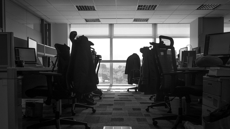 A black and white photo of an empty open-plan office.
