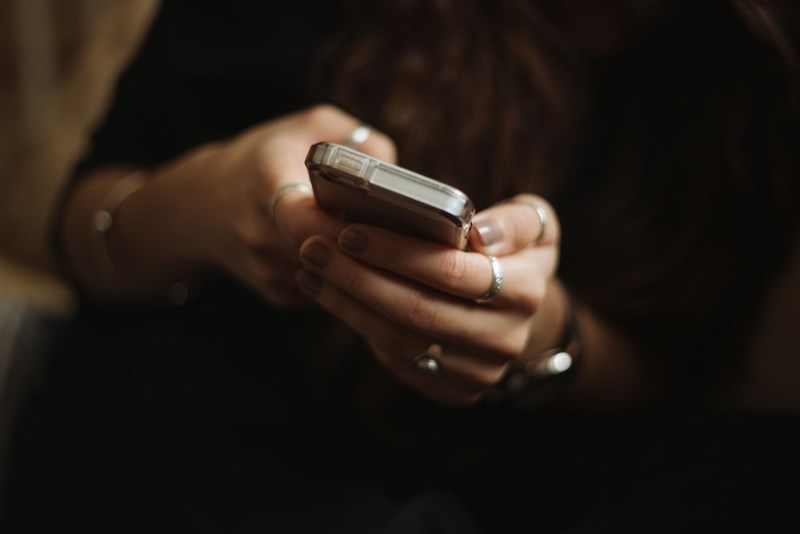 A person holds a smartphone in their hands