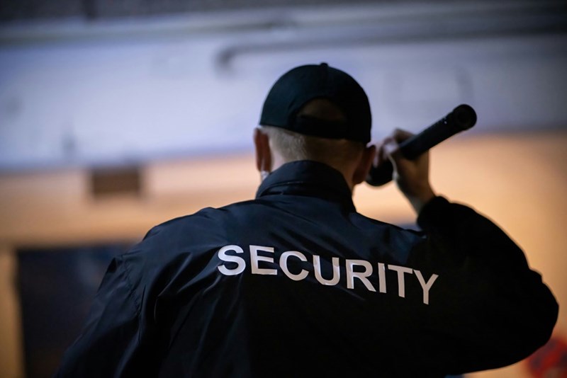 Security guard walking at night.