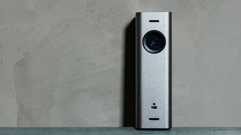 A small doorbell camera perched on top of a pipe.