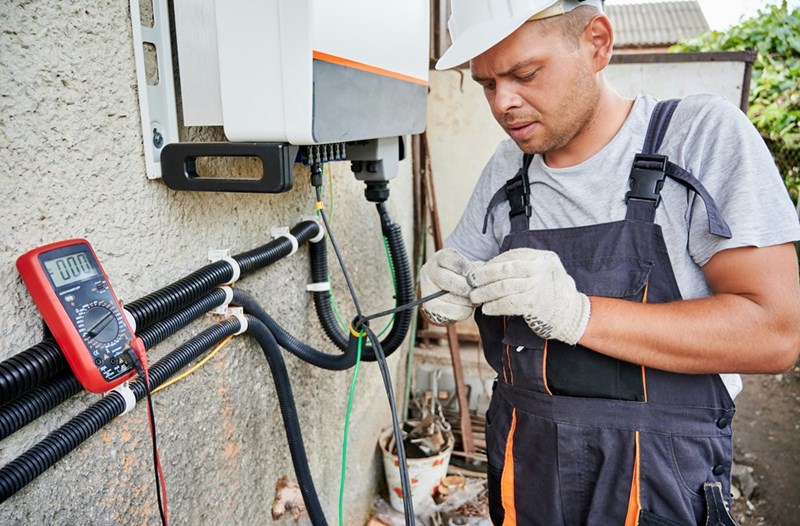 The electrician removes the connected wires.