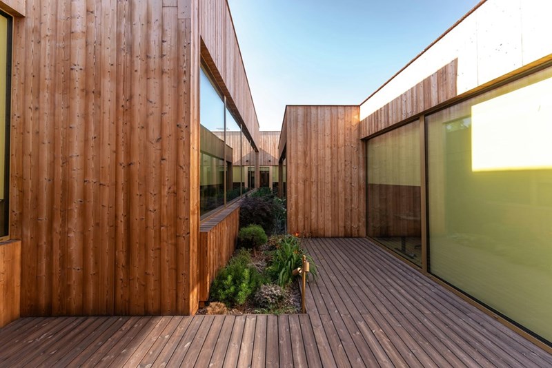 A workplace community garden sits between office buildings.