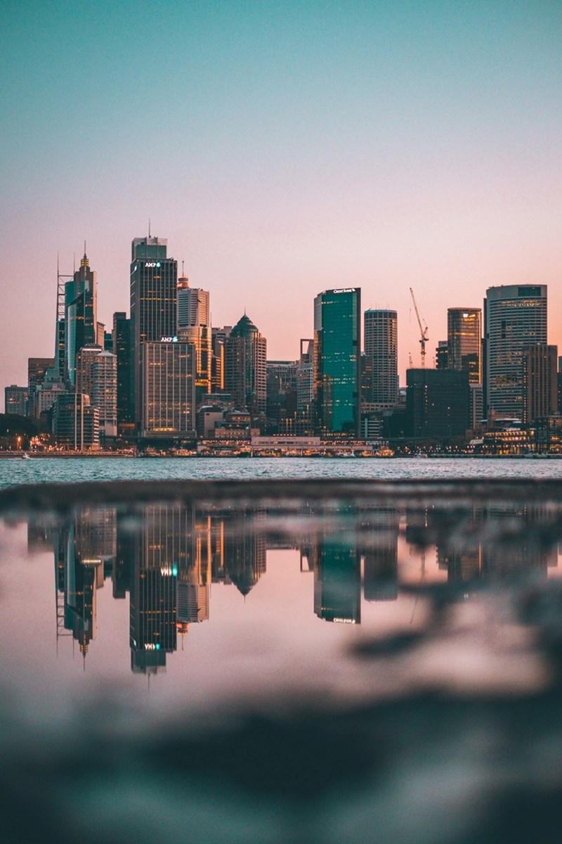 The skyline of a city as seen over water.