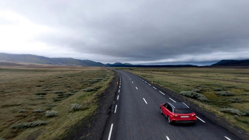 A car ride on the highway seen from the outside.