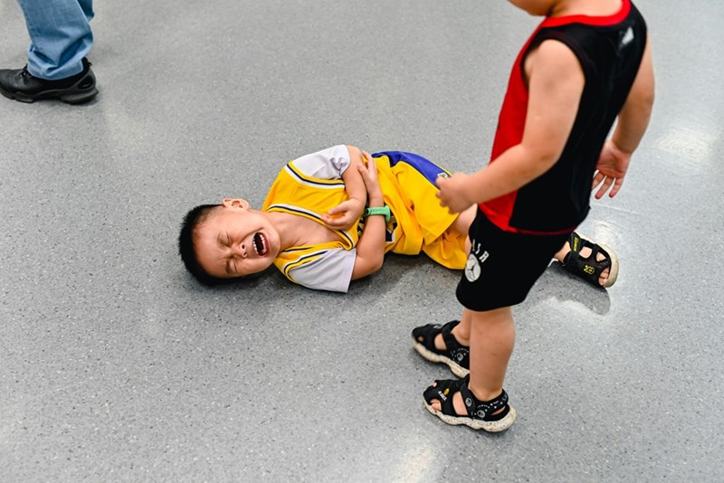 Two boys lying on the ground