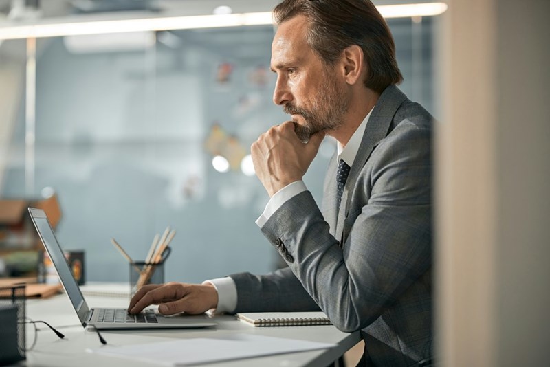 CEO reading a message from a job candidate on his laptop after the candidate reaches out directly following a rejection.