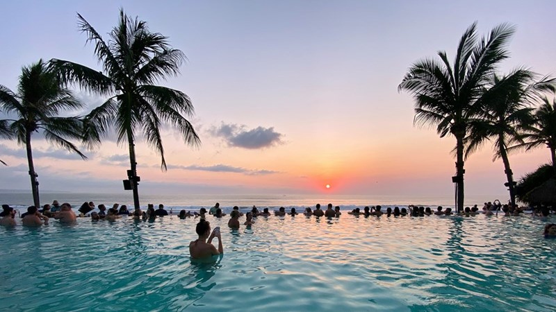 A luxurious vacation spot in Bali, where an employee is discovered to be traveling after claiming a family emergency to secure paid leave.