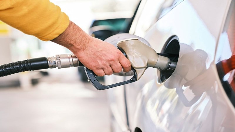 A person filling up a gas tank for their car. Representation only,