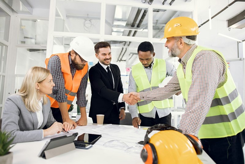 Happy construction team during conference at office
