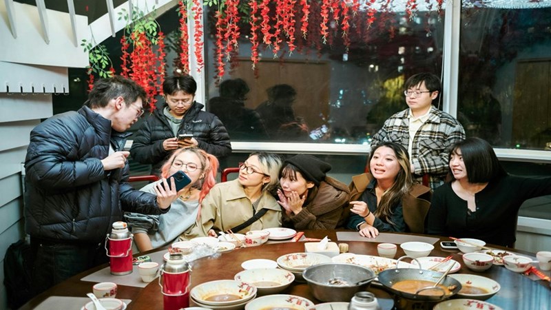 Friends enjoying eating out at a restaurant together to celebrate a birthday party. Licensed media provided as editorial context.