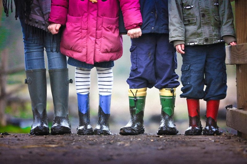 Children standing together, holding hands. Model image.
