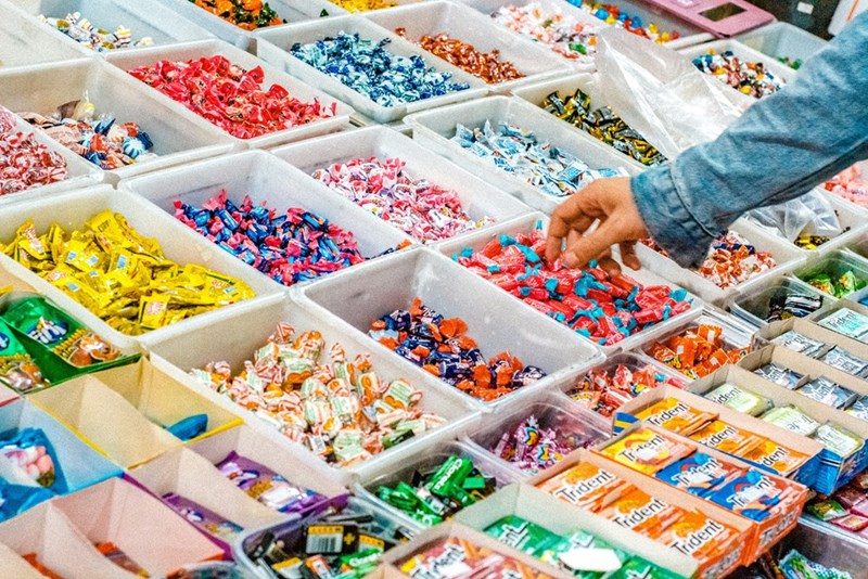 Man buying candy to share with his coworkers.