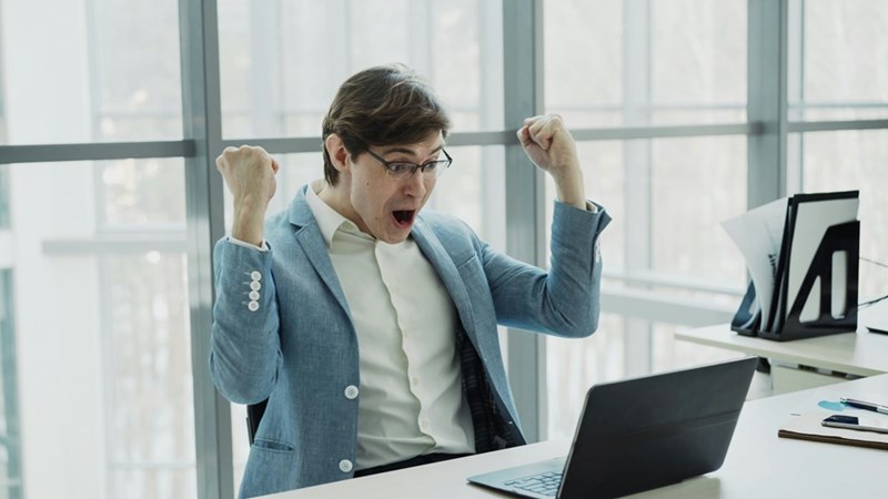 Coworker celebrating a promotion while a top-performing employee is passed over.