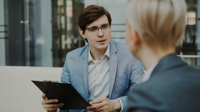 Employee meeting with his boss after being told his high perfomance makes him too valuable to promote.