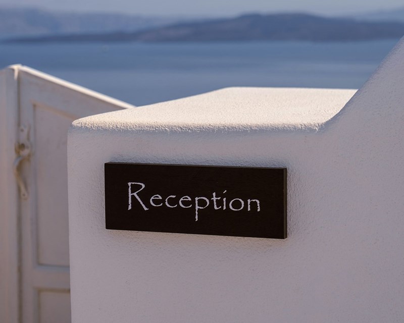 A sign that read “Reception” at a beach hotel.