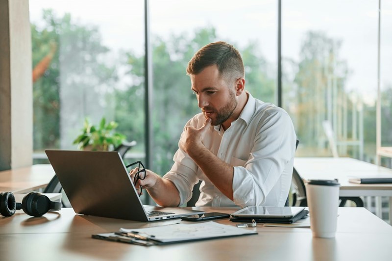 Marketing director reviewing the email thread that proved he wrote the “unusable” AI-generated newsletter he blamed on an employee.