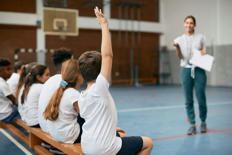 Gym teacher teaching PE in an elementary school