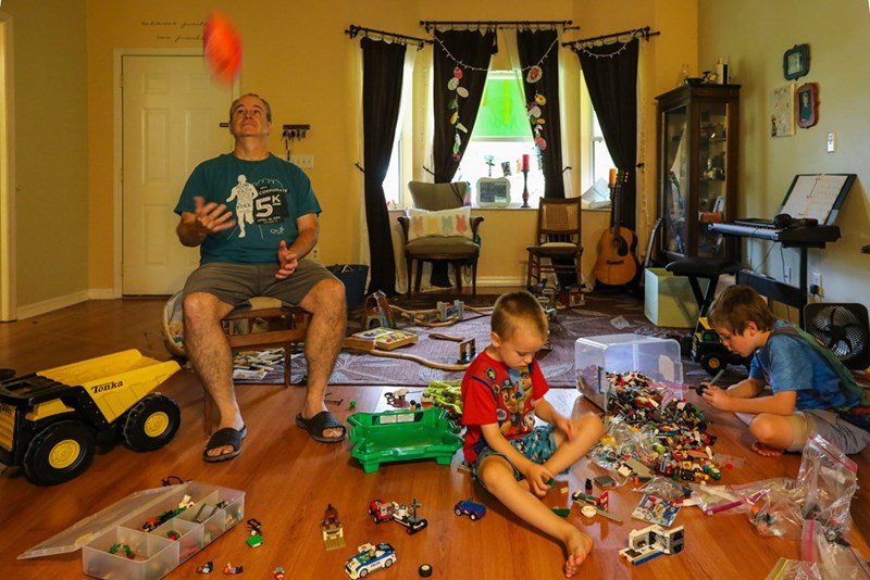 A family playing together in the living room. Model representation.