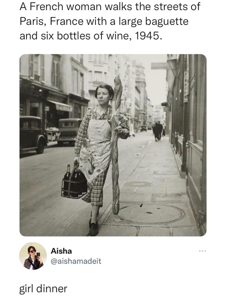 A French woman walks the streets of Paris, France with a large baguette and six bottles of wine, 1945. Aisha @aishamadeit girl dinner