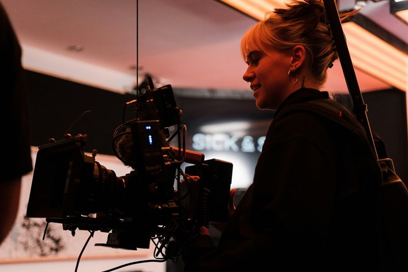 A woman standing in front of a camera