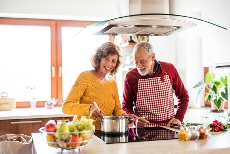 Senior couple preparing food in the kitchen