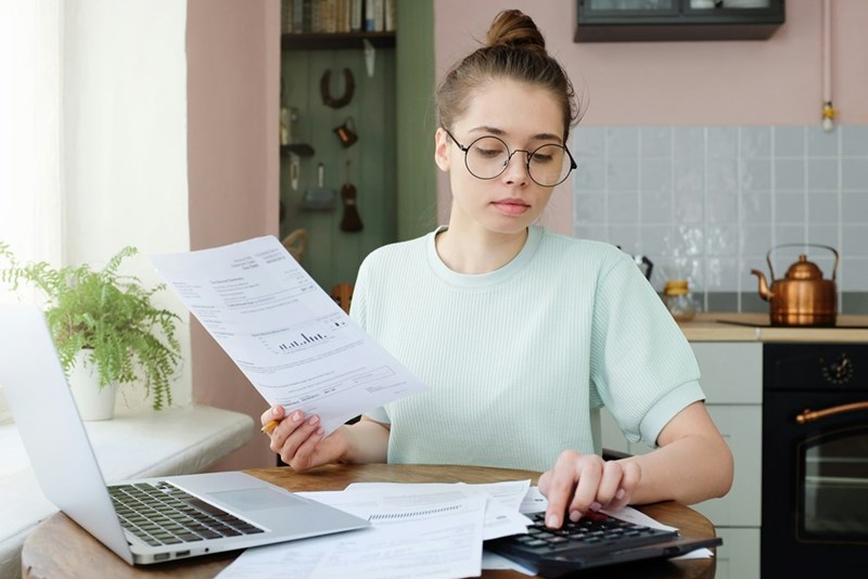 Young woman budgeting managing utilities expenses