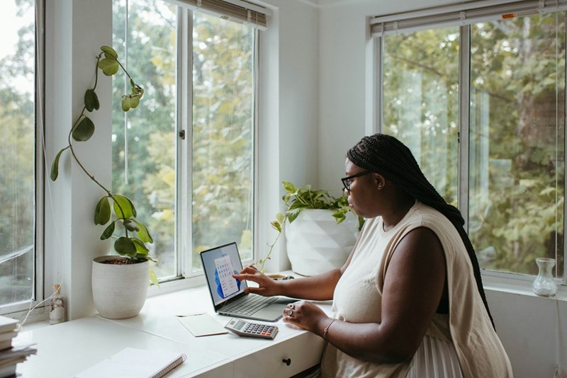 A woman works from home at a desk
