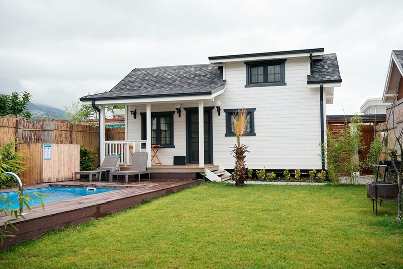 A private backyard with a swimming pool, where the homeowner allowed her neighbor's kids to swim.