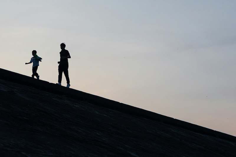 The silhouette of two people.