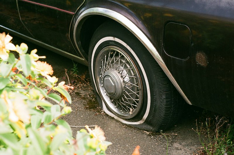 A car with a flat tire.