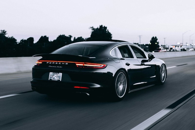 A fancy black car on the road.