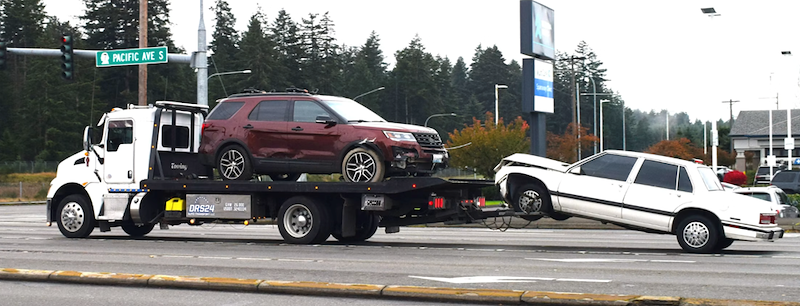 Two cars are towed away.