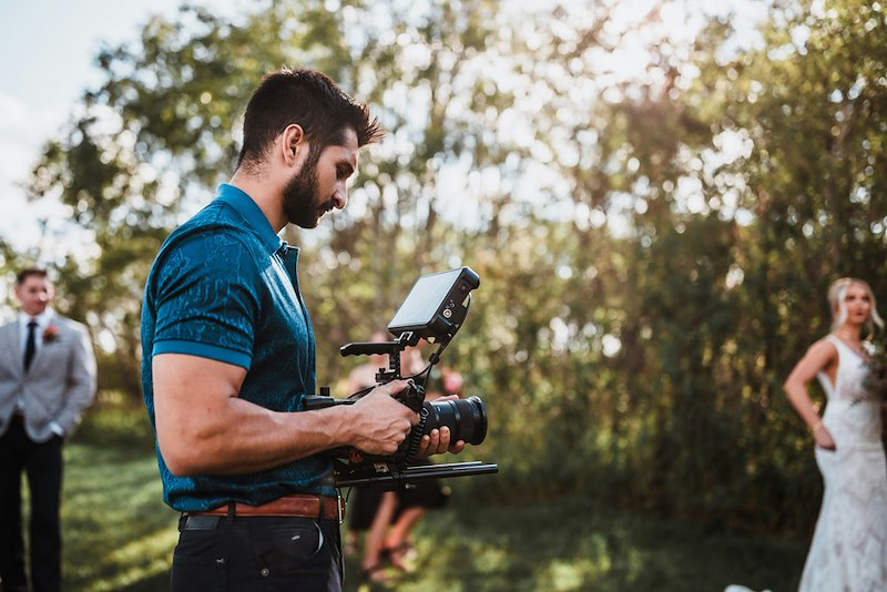 A photographer taking photos at a wedding. Scene is illustrative and does not depict actual individuals or events.