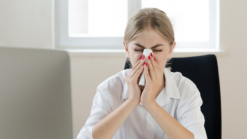 Woman sick at work.