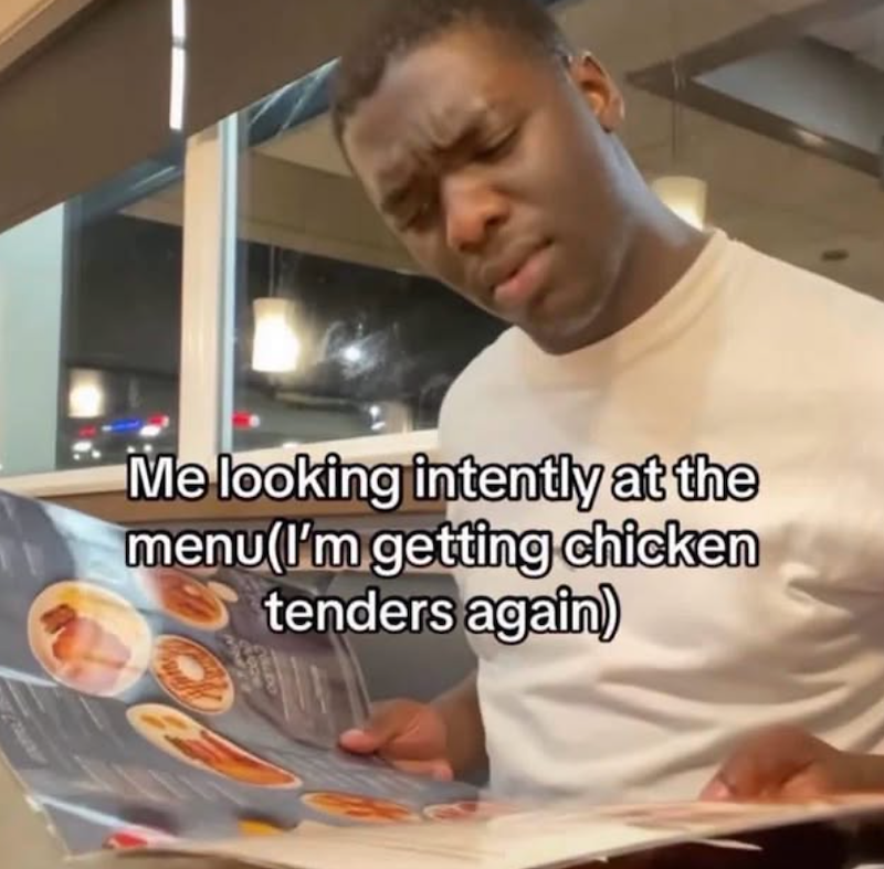 Me looking intently at the menu(I'm getting chicken tenders again)