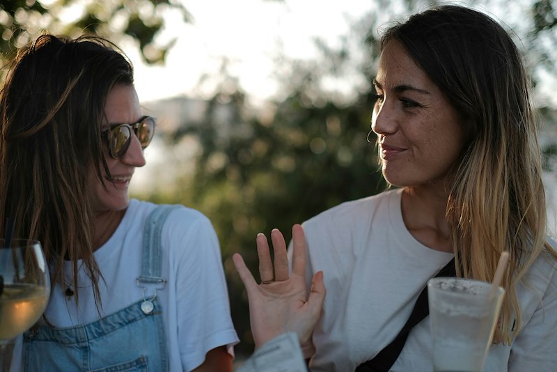 Two adult women friends spending time together. Individual pictured is a model used for illustrative purposes.